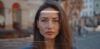 Woman's face being measuring by facial recognition AI.